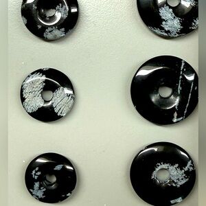Black natural stone gemstone donuts various sizes.
